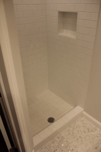 Recessed shower shelf with white ceramic subway style tiles Recessed shower shelf with white ceramic subway style tiles