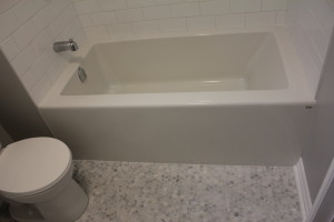 Tub wall was moved 1.5 feet into the office space and new acrylic tub is installed in place of old toilet and pedestal sink. Tub wall was moved 1.5 feet into the office space and new acrylic tub is installed in place of old toilet and pedestal sink.